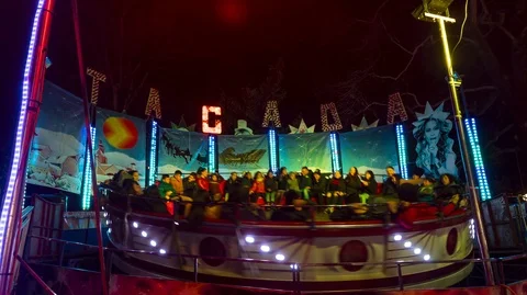 Happy people at a game "Tagada" in amusement park Video stock 121962855