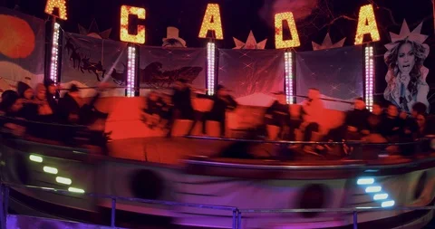 Happy people at a game "Tagada" in amusement park at the Christmas Village Video stock 122228013