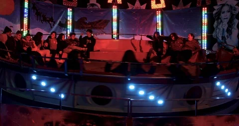 Happy people at a game "Tagada" in amusement park at the Christmas Village Video stock 122229648