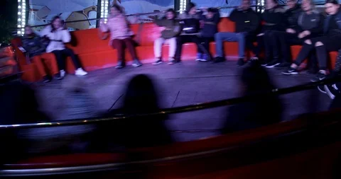 Happy people at a game "Tagada" in amusement park at the Christmas Village Video stock 122230225