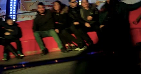 Happy people at a game "Tagada" in amusement park at the Christmas Village Video stock 122231013