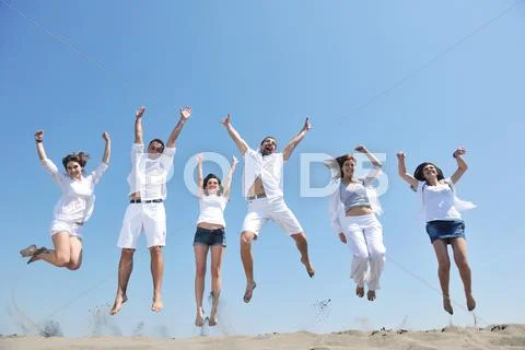 Happy people group have fun and running on beach Stock Photos