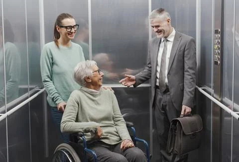 Happy people having a conversation in the elevator Stock Photos