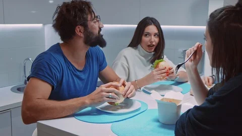 Happy people laughing while having lunch with friends Stock Footage 102219494