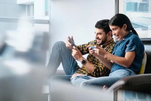 Happy People Playing Video Game With Smartphone And Laughing Stock Photos
