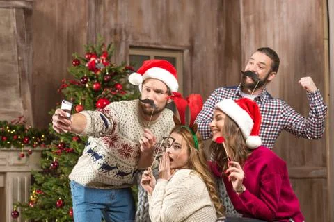 Happy people taking selfie at christmastime Stock Photos