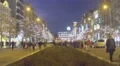 Happy people walking in beautiful decorated city center, evening time, tourism HD Footage
