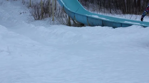 Happy peoples sliding down on snow tube. Evening blue light. Stock Footage 100818492