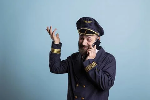 Happy pilot using smartphone for telephone calls 写真素材