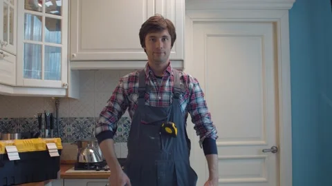 Happy plumber in the kitchen Stock Footage 131211214