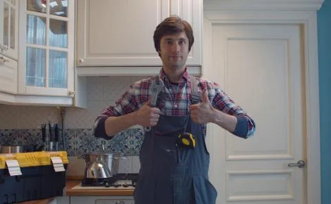 Happy plumber in the kitchen Stock Photos