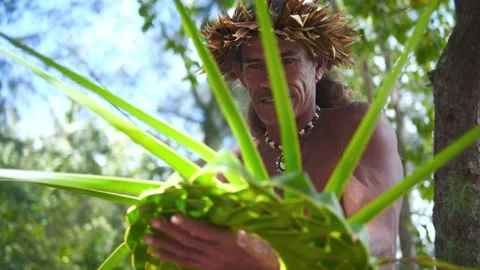 Happy Polynesian Pacific islander man making traditional Tahitian hat from palm  Stock Footage 143579261