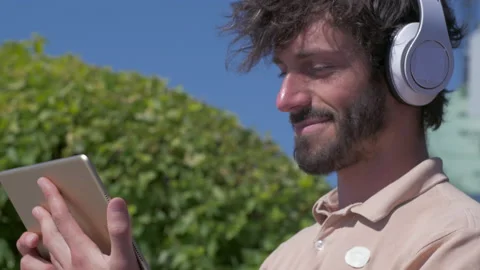 Happy positive man using digital tablet outdoors Stock Footage 132842213