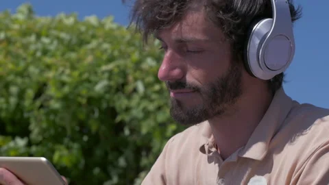 Happy positive man using digital tablet outdoors Stock Footage 132842799