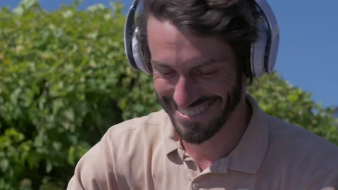 Happy positive man using digital tablet outdoors Stock Footage 132843299