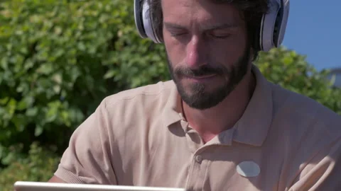 Happy positive man using digital tablet outdoors Stock Footage 132844020