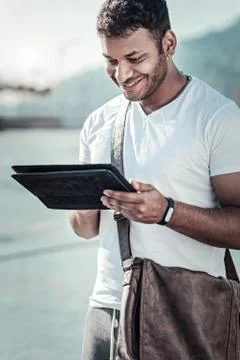 Happy positive man using a tablet Stock Photos