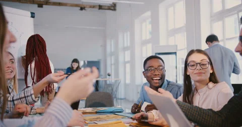 Happy positive multiethnic creative team discussion at modern trendy office Stock Footage 107381461