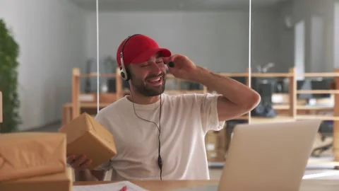Happy post manager talking with client near parcel boxes in office Stock Footage 153843623