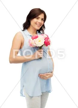 Happy pregnant woman with flowers touching belly Stock Photos