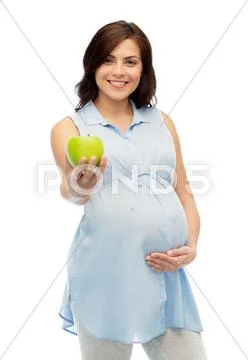 Happy pregnant woman holding green apple Stock Photos