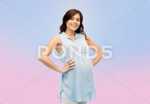 Happy pregnant woman touching her big belly Stock Photos