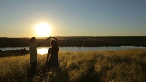 Happy pretty couple having fun outdoors through a field. Countryside. Stock Footage 79073830