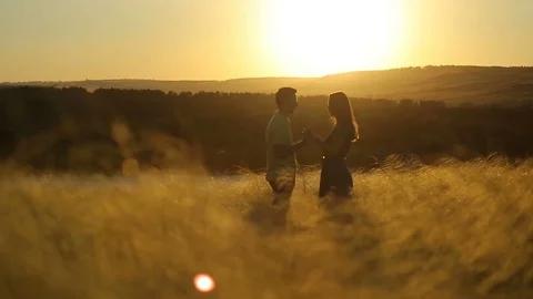 Happy pretty couple having fun outdoors through a field. Countryside. Stock Footage 79073952