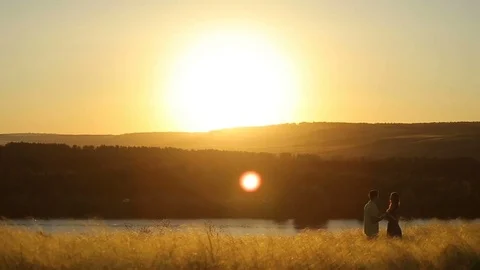 Happy pretty couple having fun outdoors through a field. Countryside. Stock Footage 79074043