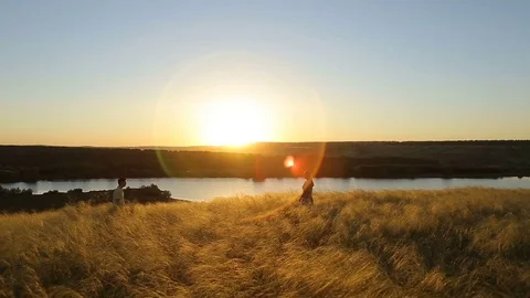 Happy pretty couple having fun outdoors through a field. Countryside. Stock Footage 79074078