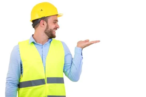 Happy professional engineer pointing to something isolated on white background. Foto stock