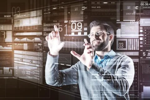 Happy programmer touching the screen and smiling while working Stock-Fotos