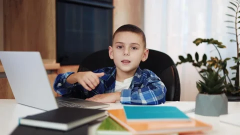 Happy pupil showing thumb up while using modern laptop during home education Stock-Footage 258320269