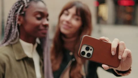 Happy queer couple or two girls on a vacation taking selfie, kissing and Stock Footage 303288553