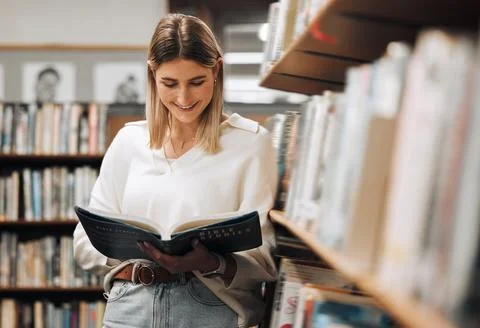 Happy, reading or student in library for books, educational knowledge or Stock Photos