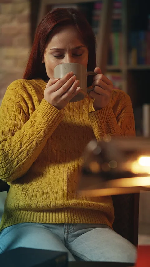 Happy redhead female drinking flavored coffee in bookshop cafe, leisure time Stock-Footage 342733475