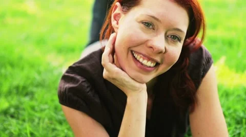 Happy redhead relaxing on meadow Stock Footage 7737154
