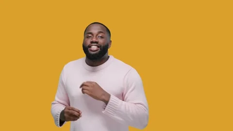 Happy relaxed black man dancing against yellow background, having fun on party Stock Footage 165237579