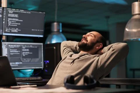 Happy relaxed developer sitting laid back on chair 스톡 사진