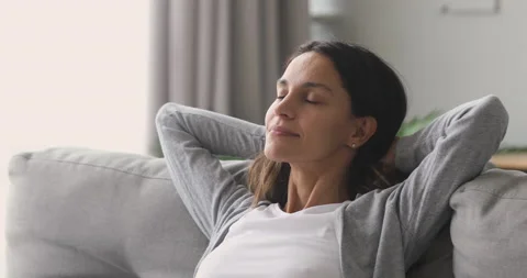 Happy relaxed woman rest lounge on couch enjoy peaceful day Stock Footage