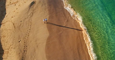 Happy Retired Couple Walking Down the Beach Stock Footage 68031919
