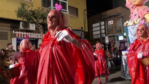 Happy revellers dressed as candy parade and dance during Carnival of Aguilas Stock Footage 73642382