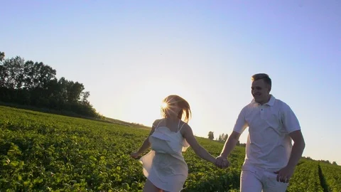 Happy romantic couple having fun outdoors. Love. Couple running away on the Stock Footage 95932193