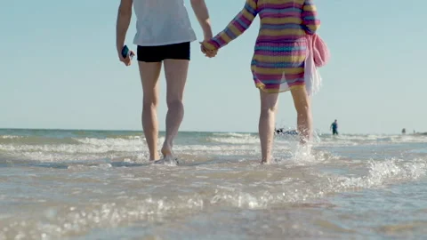 Happy Romantic Middle Aged Couple Enjoying Beautiful Sunset Walk on the Beach Stock Footage 134839320