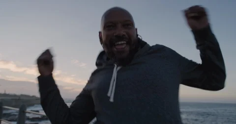 Happy runner man dancing celebrating successful fitness goals cheerful black Video stock 92772096