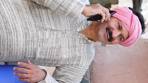 Happy rural indian dairy farmer talking on phone after good milk production.. Stock Footage 282580098