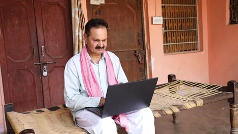 Happy rural indian man using laptop computer at village house do thumb up. .. Stock Footage 282580043