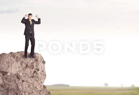Happy salesman on cliff in the country Stock Photos