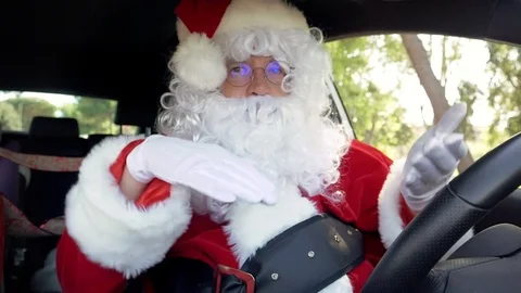 Happy Santa Claus playing with hat while driving car dancing Stock Footage 81481698