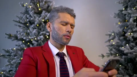 Happy santa guy look at cell phone screen overjoyed by victory success at home Stock Footage 167651991